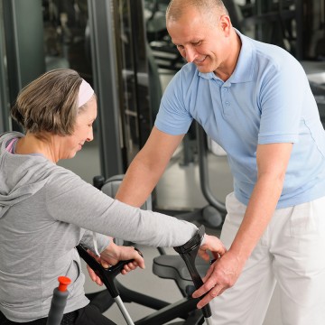 therapist helping client with specialized walker
