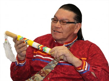 indigenous man holding a talking stick