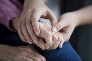 young hands holding elderly's hands