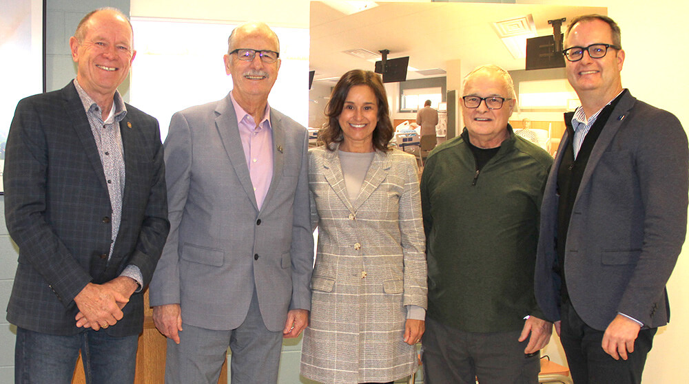 five individuals standing and smiling for the one year anniversary of the dialysis unit at Bethesda Regional Health Centre