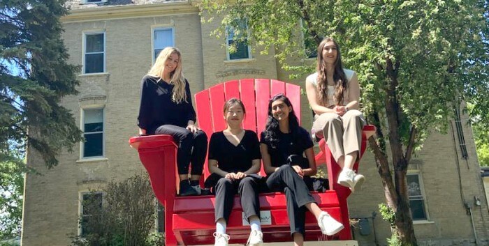 First year medical students on big red chair