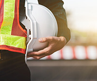 construction worker holding hard hat