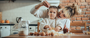 image of mom and toddler baking in the kitchen