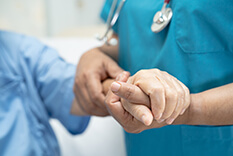 image of nurse holding a patients wrist