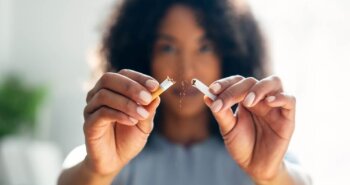 female breaking a cigarette